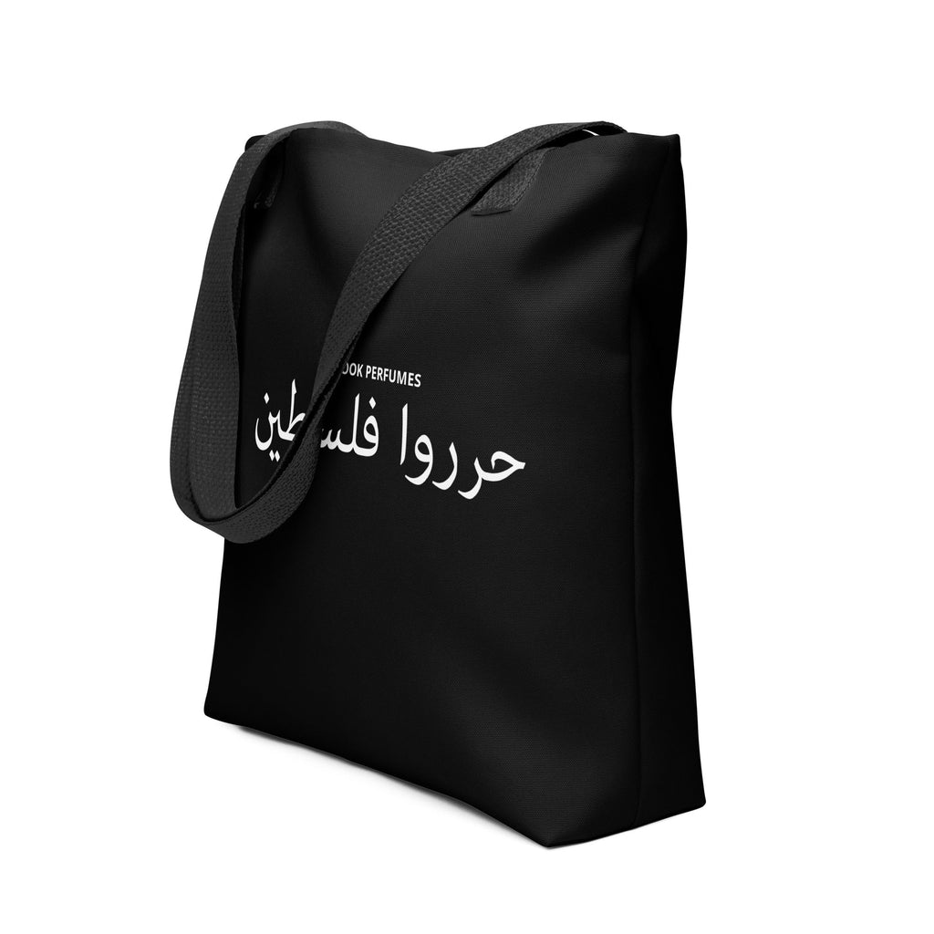 Black tote bag with "Filastin Hura Free Palestine" slogan and Rook Perfumes branding, featuring a bold, unisex design.