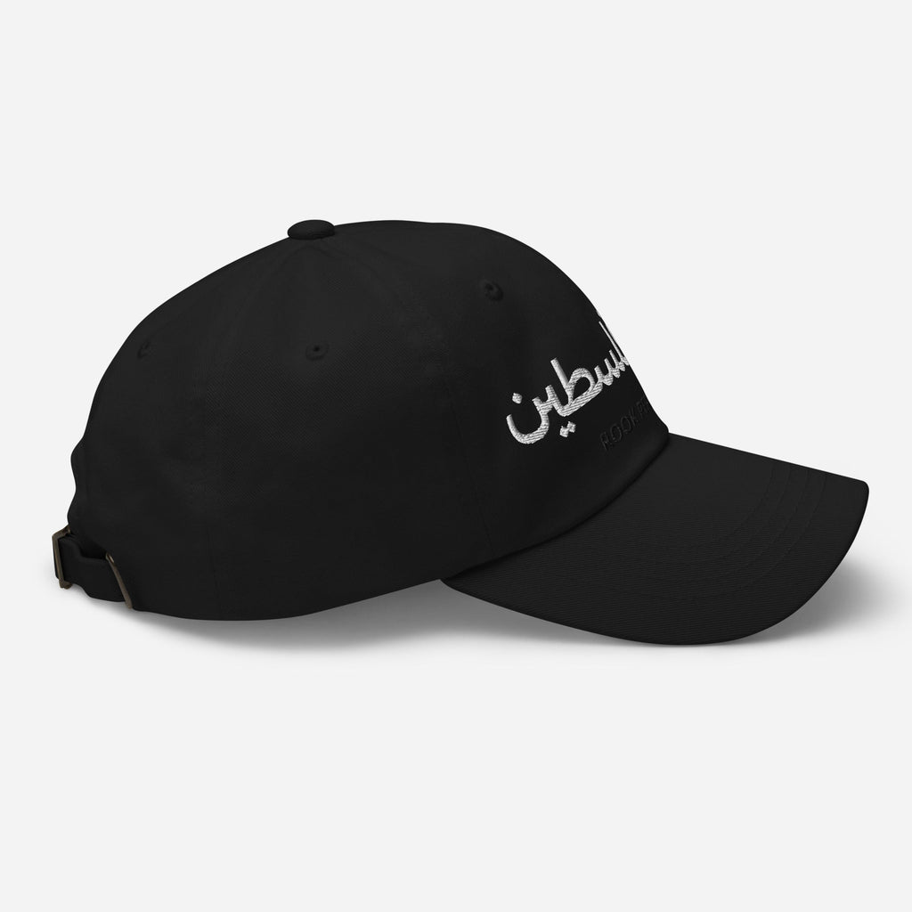 Black cap with "Free Palestine" text from Rook Perfumes, featuring bold lettering and a classic unisex style.