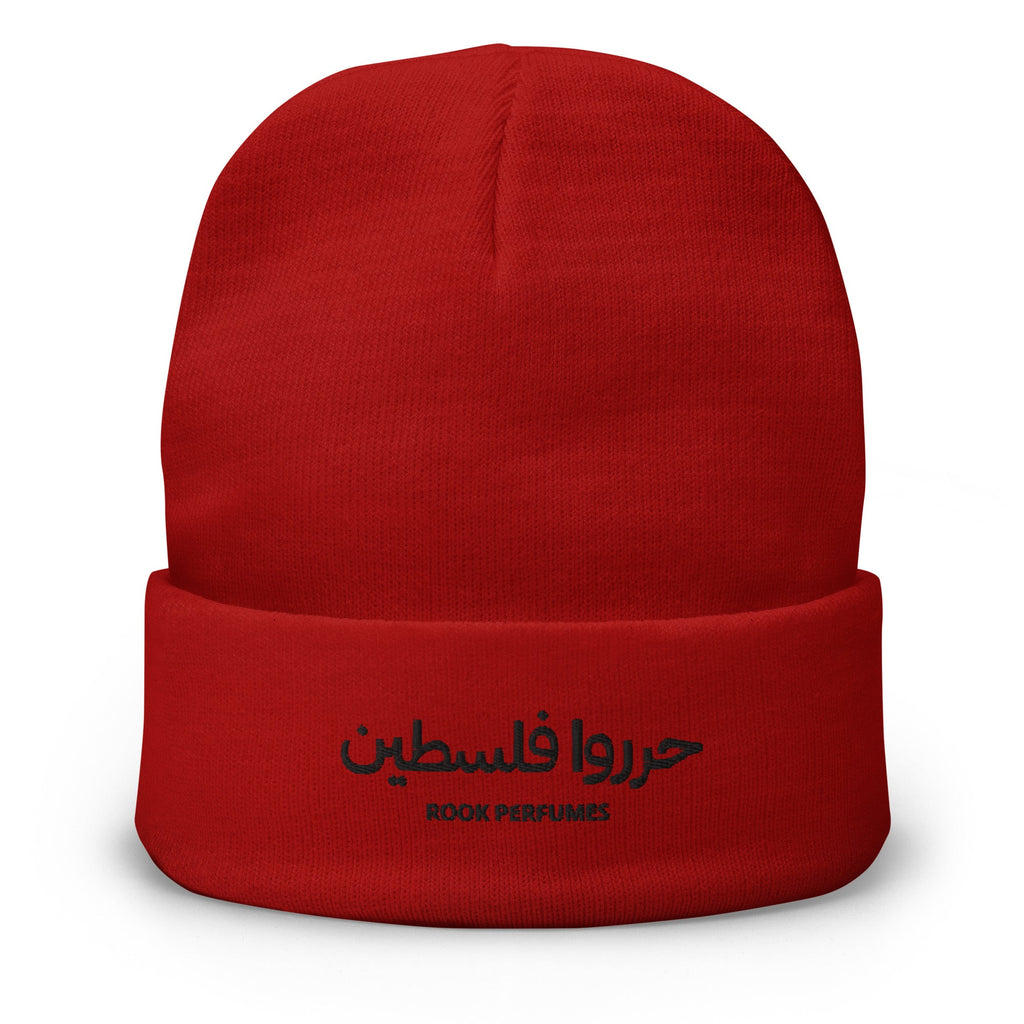 Red embroidered Free Palestine beanie by Rook Perfumes, featuring a unisex design with bold lettering and soft knit fabric.